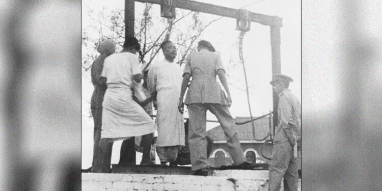 Former Premier U Saw, of Burma, stands on the gallows at Insien prison in Rangoon, on May 8, 1948, as the hangman’s assistants manacle his hands behind him. / AP