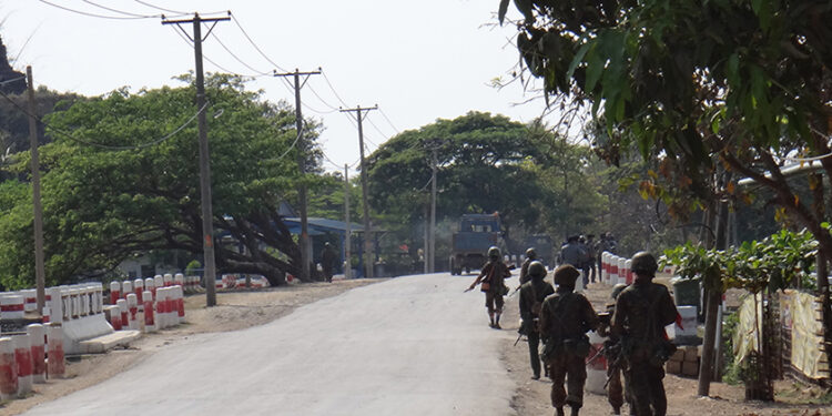 Police and Army personnel jointly patrol along a main road in downtown Mrauk-U in March 2019. / Moe Myint / The Irrawaddy