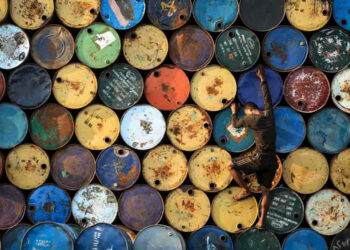 A worker at a used drum warehouse on the outskirts of Rangoon in May. / Hein Htet / The Irrawaddy