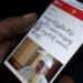 A mobile phone user reads Burmese-language news on an Internet-enabled device. / San Yamin Aung / The Irrawaddy