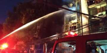 A fire truck shoots water at a building that caught fire in Yangon on Wednesday morning. / Yangon Western District Fire Service Department