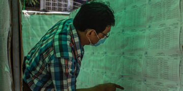 A Yangon resident checks his name on the voter list displayed for the second time on Oct. 12, 2020. / Htet Wai / The Irrawaddy