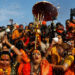 Lakshmi Narayan Tripathi (center), chief of the "Kinnar Akhada" congregation for transgender people, and other members take a dip during the first "Shahi Snan" (grand bath) at "Kumbh Mela," or the Pitcher Festival, in Prayagraj, previously known as Allahabad, India, on Tuesday. / Reuters
