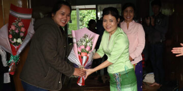 Nang Pu, in green, accepts flowers from a supporter upon her release from prison in Kachin State on Friday. / Htoi Awng