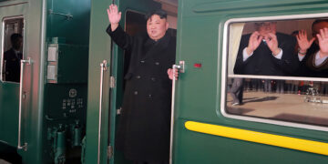 North Korean leader Kim Jong Un waves from a train as he departs for a summit in Hanoi, in Pyongyang, North Korea, in this photo released by North Korea's Korean Central News Agency on Saturday.