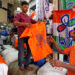 A customer (R) buys a T-shirt with an image of Prime Minister Narendra Modi at a shop at a market ahead of India's general election, in Kolkata, India on March 26, 2019. / Reuters