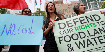 Environmental activists protest in front of the United Nations Conference Centre (UNCC) in Bangkok, Thailand, where the Bangkok Climate Change Conference took place on Tuesday. / REUTERS
