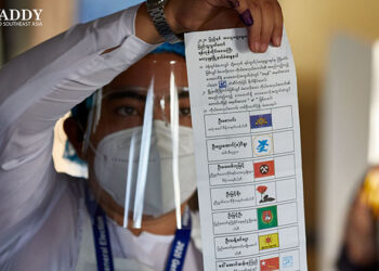An official inspects a ballot at a polling station in Kawhmu Township, Yangon Region during the Nov. 8 general election. / The Irrawaddy