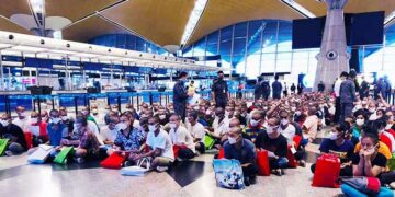 The 280 Myanmar migrant detainees wait at Kuala Lumpur International Airport before leaving for Myanmar on Sunday. / San Win