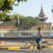 A woman going to work in downtown Mandalay by bike. / The Irrawaddy