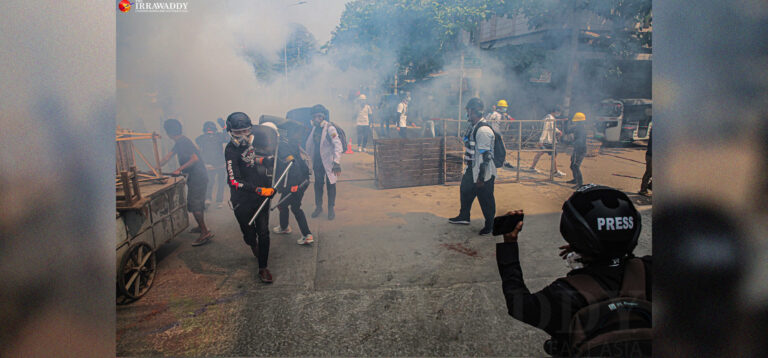 A journalist covers a crackdown against an anti-regime demonstration in Mandalay. / The Irrawaddy