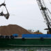 A crane moves sand from a ship on the Mekong River in Hau Giang Province, Vietnam, on December 19, 2018. / Reuters