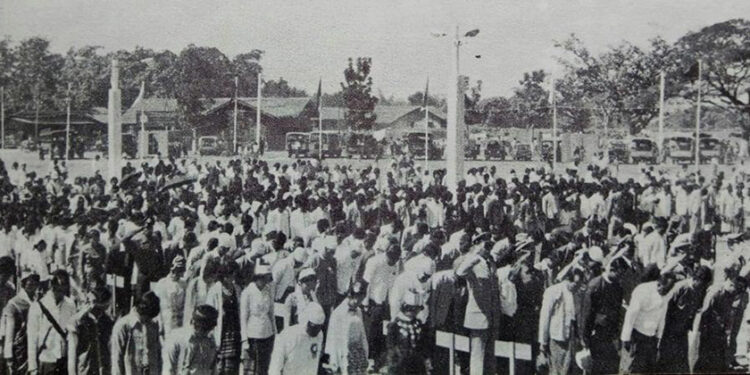 People sing the national anthem during the 1981 Union Day in Pathein Township.