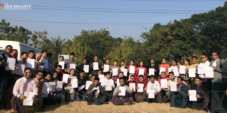 Lawmakers display their swearing-in papers on Thursday after taking their oaths as parliamentarians at an improvised ceremony. / The Irrawaddy