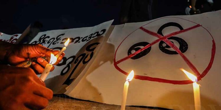 Protesters in Mandalay hold a candlelight vigil on Tuesday night at the southern side of the old palace in Mandalay after the arrest of fellow protesters. / Zaw Zaw / The Irrawaddy