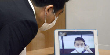 A demonstration of an interpretation system via videolink is shown to the press at the Foreign Residents Support Center in Tokyo's Shinjuku district on July 6, 2020. / Kyodo