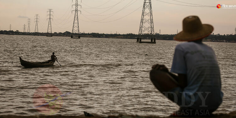 Power lines for the central grid over the Bago River on the outskirts of Yangon. / The Irrawaddy