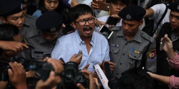 Ko Wa Lone, one of the detained Reuters reporters, talks to the media after the pair were charged by Yangon’s Northern District Court on Monday.  / Myo Min Soe / The Irrawaddy