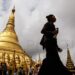 A Buddhist pilgrim walks on the terrace of the Shwedagon pagoda on an overcast day in September. / Kyaw Phyo Tha / The Irrawaddy