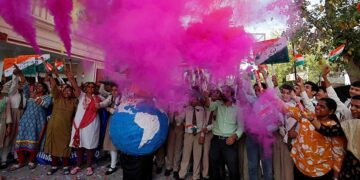 Teachers and students release colored smoke as they celebrate after India shot down one of its satellites in space with an anti-satellite missile in a test, inside their school premises in Ahmedabad, India, on Wednesday. / Reuters