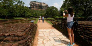 A tourist take pictures of the UNESCO listed World Heritage Site Sigiriya Rock Fortress in Sigiriya, Sri Lanka, on October 11. / Reuters