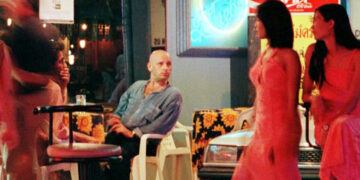 Sex workers wait for customers in a red-light area of central Bangkok. / Reuters