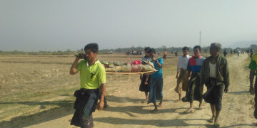 The body of Ma Yi Yi Soe, killed by a stray bullet in a clash near her village in Rathedaung Township, is carried to a graveyard on Feb. 20. / Min Aung Khine / The Irrawaddy