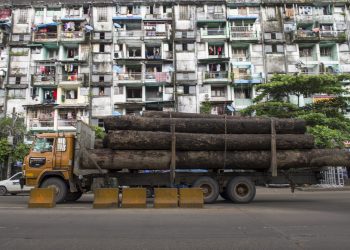 A cargo truck transports logs in Yangon in 2016.