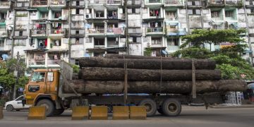A cargo truck transports logs in Yangon in 2016.