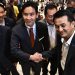 Pita Limjaroenrat (center), leader of the Move Forward Party and candidate for prime minister, shakes hands with Puea Thai Party leader Cholnan Srikaew after holding a meeting with the eight-party coalition in Bangkok on July 17, 2023. / AFP