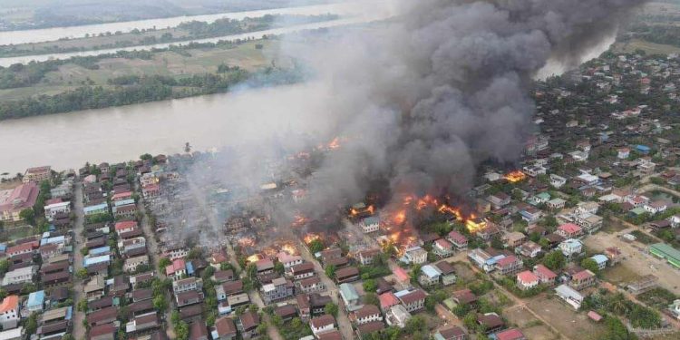 Flames and smoke rise from Dhamma Tha village as over 300 houses are destroyed in a bombardment by the Myanmar Navy. / ZarNi Media Channel