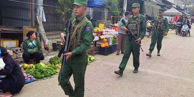 MNDAA soldiers on patrol at a market in Pansai Town, Shan State on November 29, 2023. / The Kokang