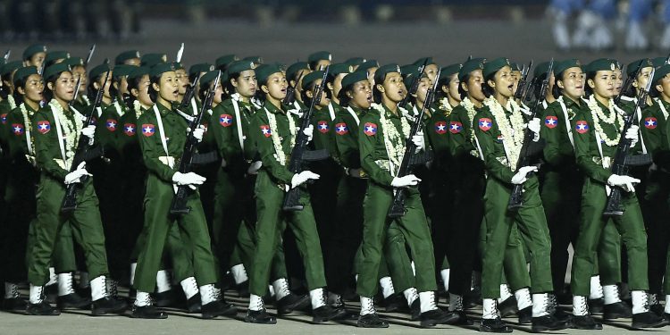Female soldiers take part in the Armed Forces Day parade in Naypyitaw on March 27, 2024. / AFP