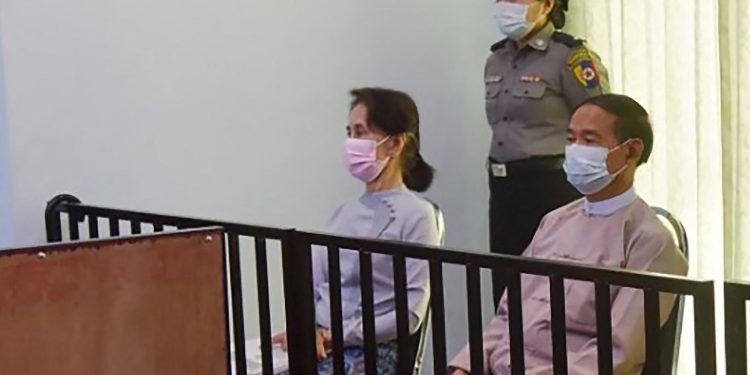 Detained civilian leader Daw Aung San Suu Kyi (left) and detained President U Win Myint (right) are seen during their first court appearance in Naypyitaw on May 24, 2021. / AFP