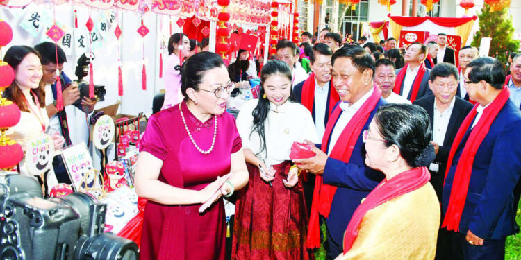 Admiral Tin Aung San (holding a red box) with Chinese Ambassador to Myanmar Ma Jia at Chinese New Year celebrations in Yangon in January. / MOI