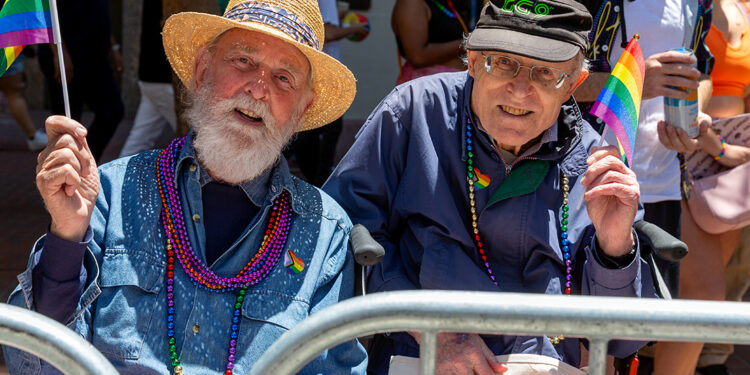 A couple who have been together for over 50 years enjoy the parade.